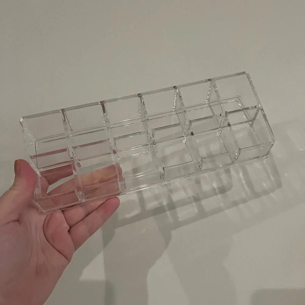 12 space acrylic holder. Great for nail polish or lipstick.